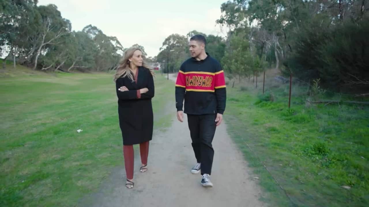 Koolyn Briggs walking and talking with Living Black's Karla Grant down a park pathway