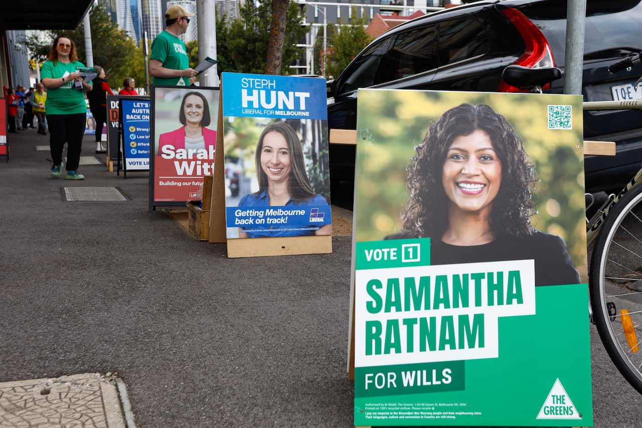 Signs outside an early voting booth including one for Samantha Ratnam