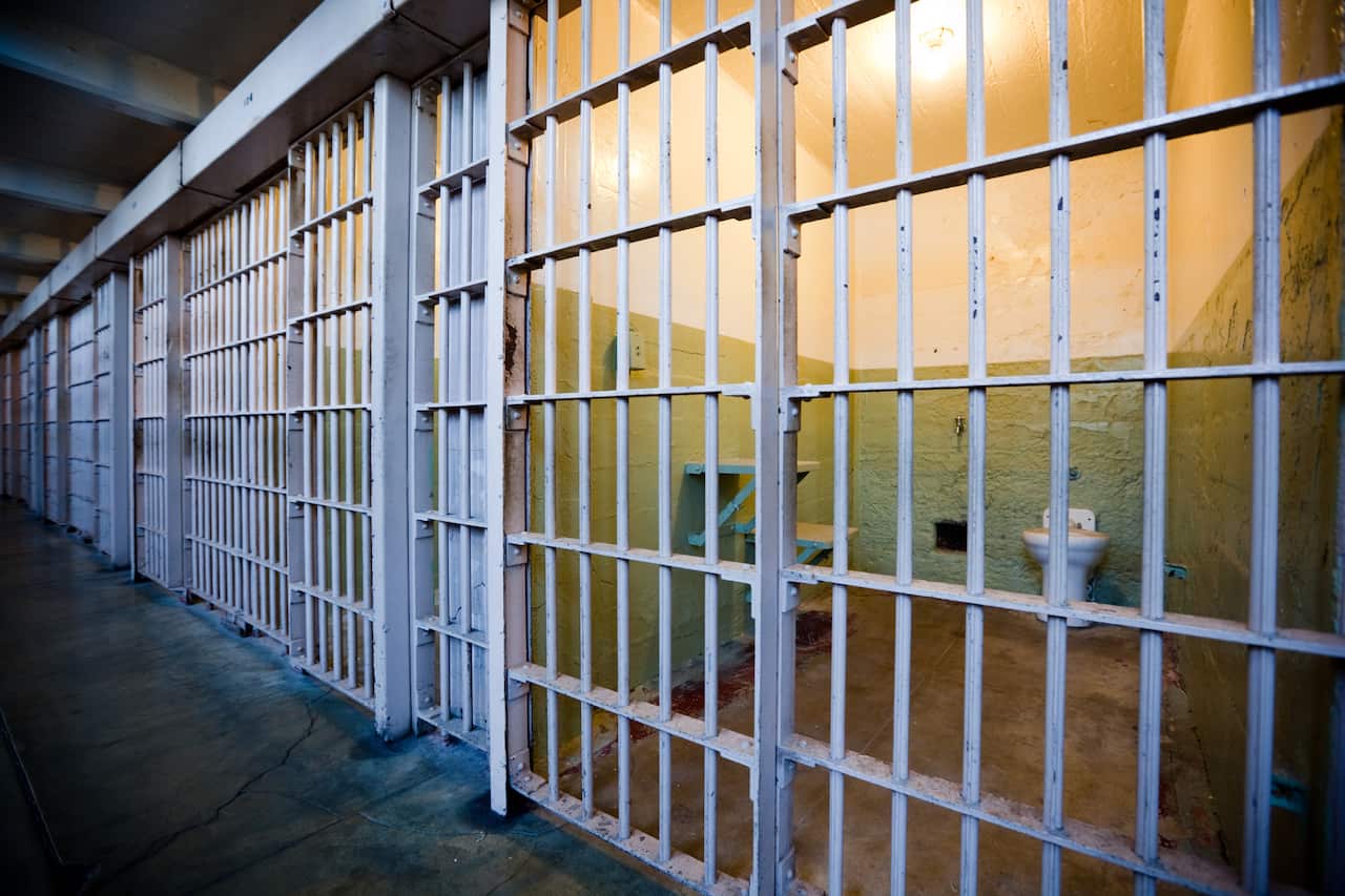 A row of locked prison cells.