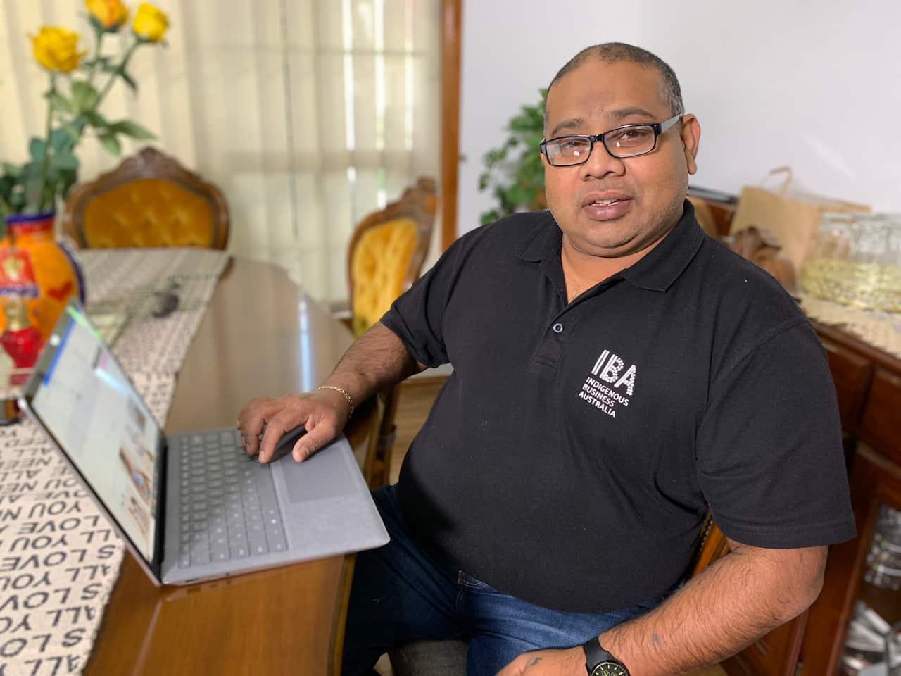 IBA's Senior Business Development Manager David Deo sits at a computer 