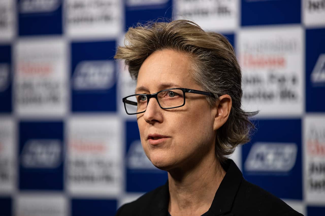 A woman speaks at a press conference
