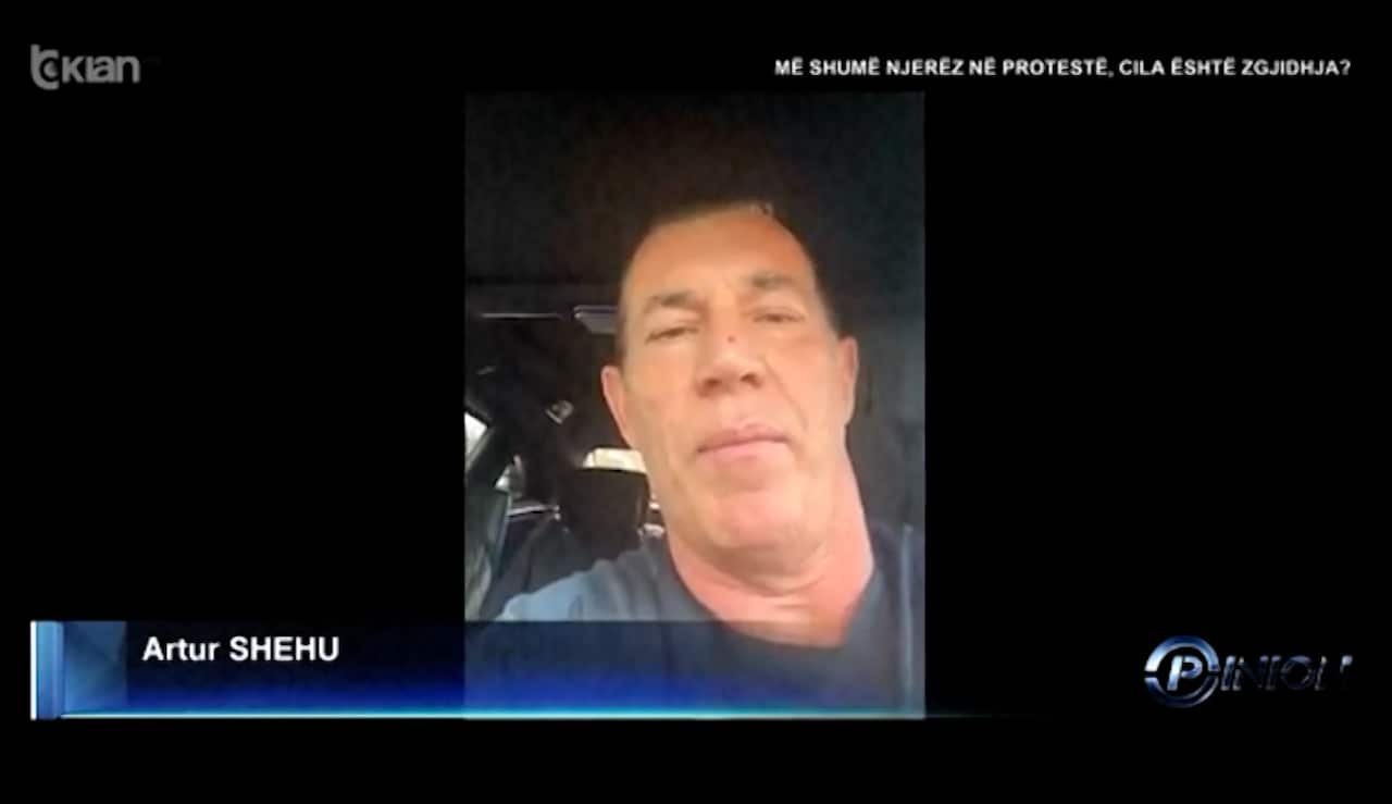 Still image from a video of a man in a car