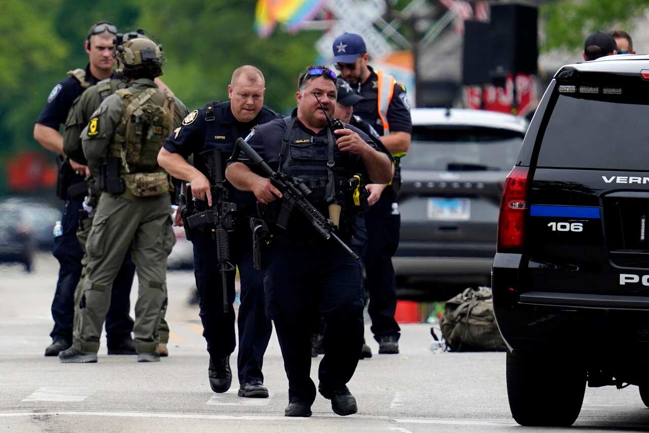 Law enforcement personnel in uniforms standing in street.