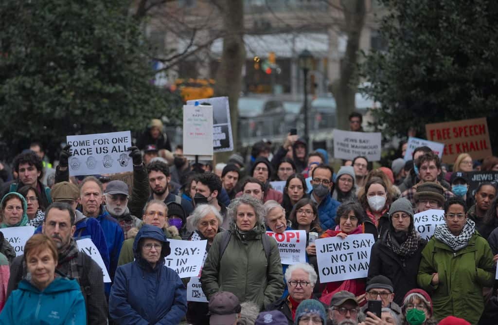 A group of protesters carry signs during a rally. 