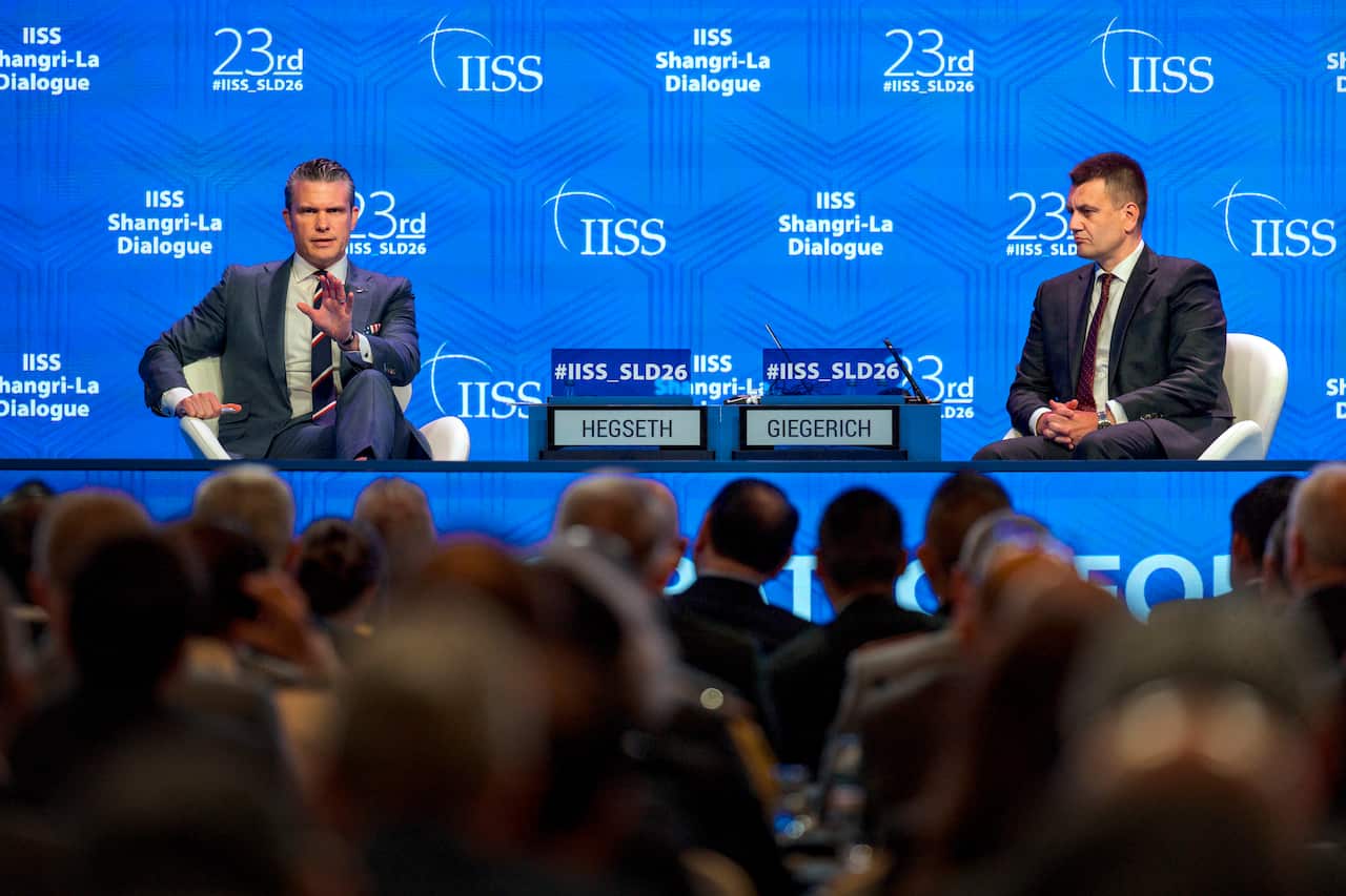 Pete Hegseth sits in front of an audience in Singapore and answers questions.