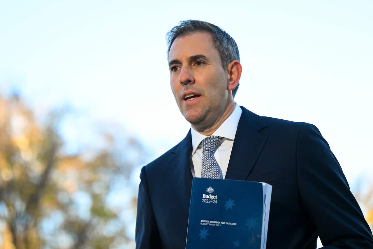 A man wearing a suit and tie standing outside.