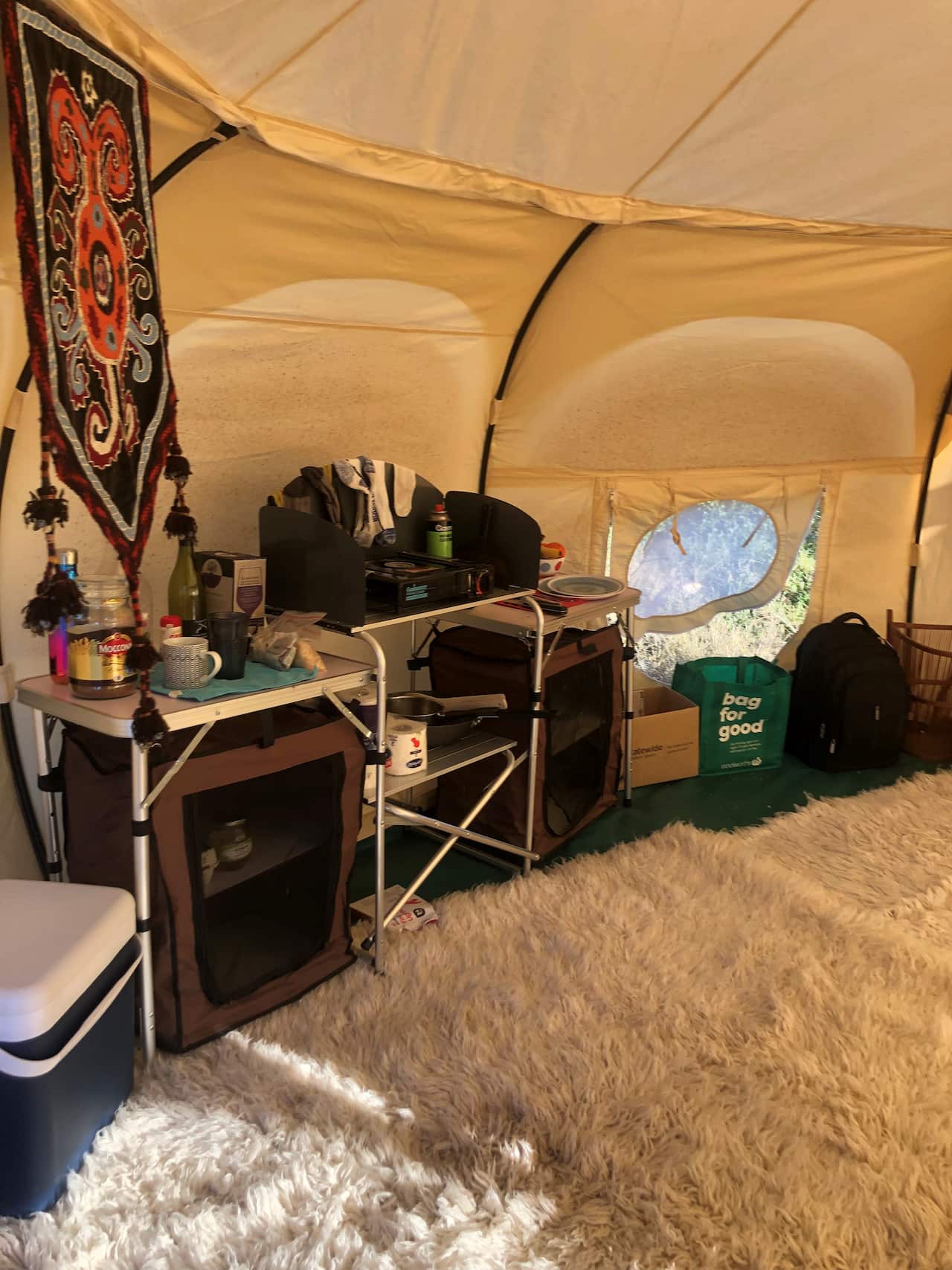 The inside of a tent storing someone's household possessions