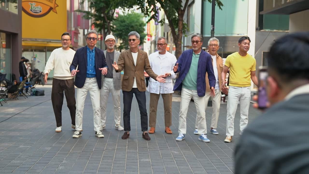 A group of older men dancing.