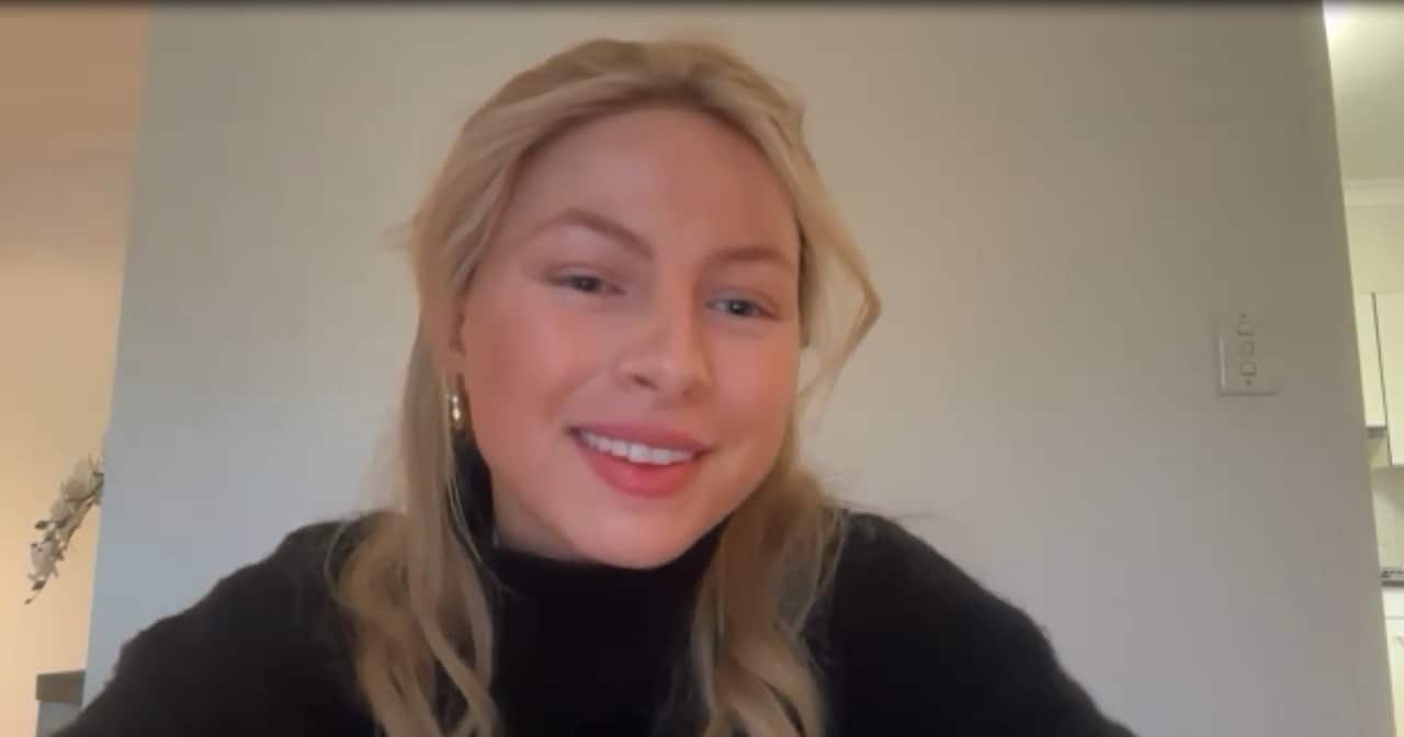 A young blonde woman smiling 