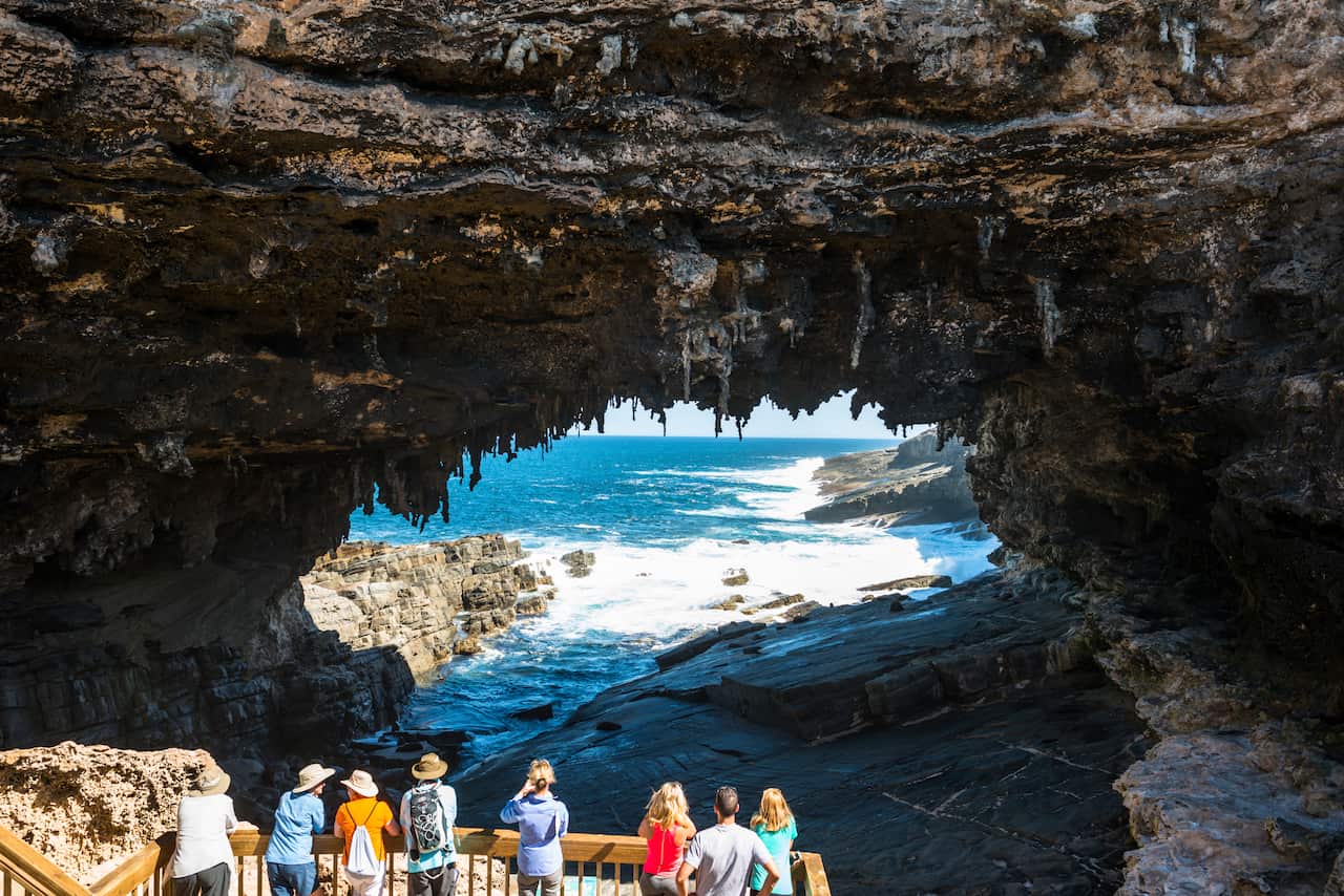 A group of people standing at a lookout at Admirals Arch, Flinders Chase National Park, Kangaroo Island