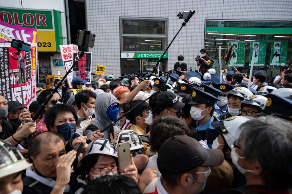 Protesters against the state funeral for Shinzo Abe are seen confronting police blocking the road to the venue in Tokyo. 
