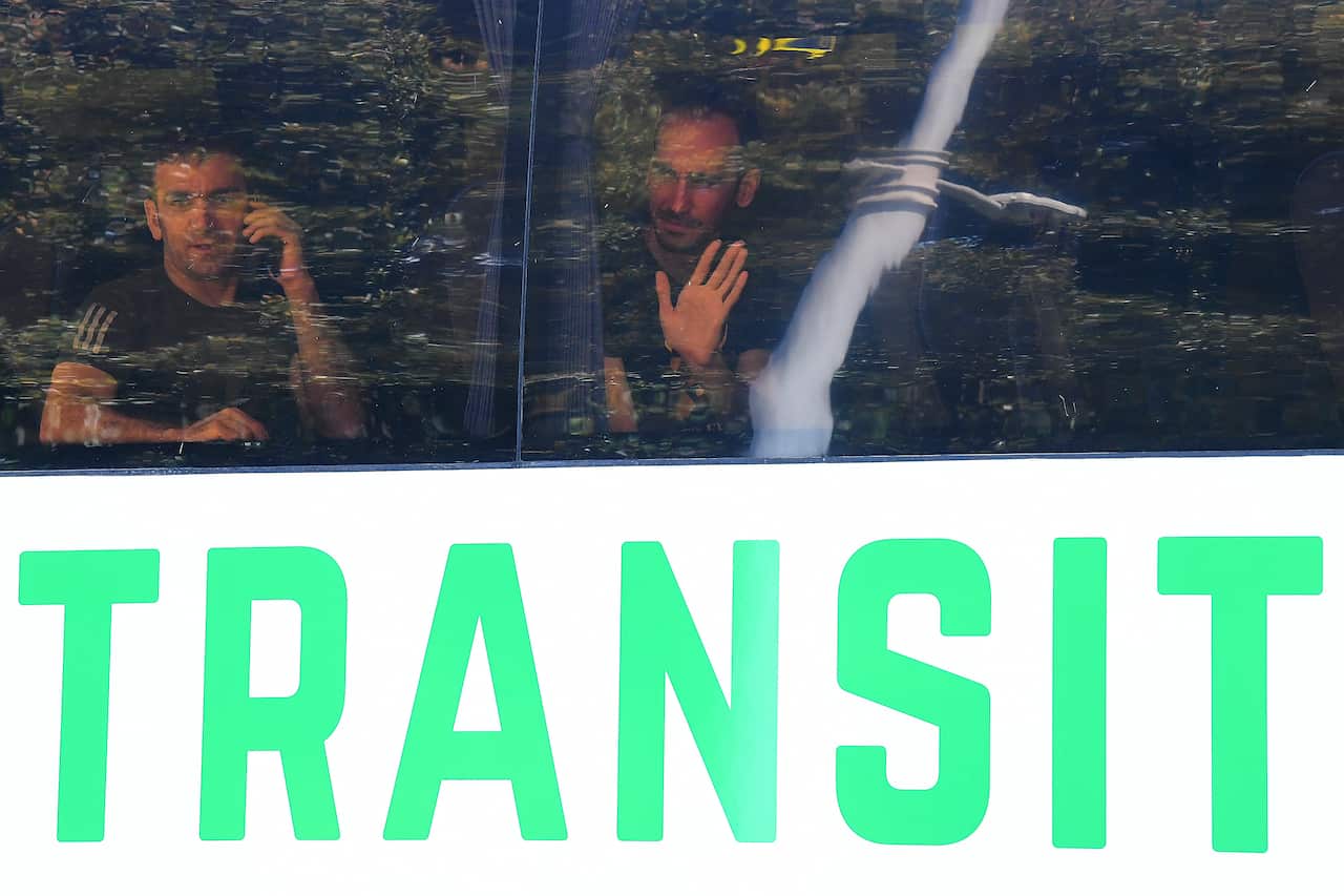 Two men in a bus looking out