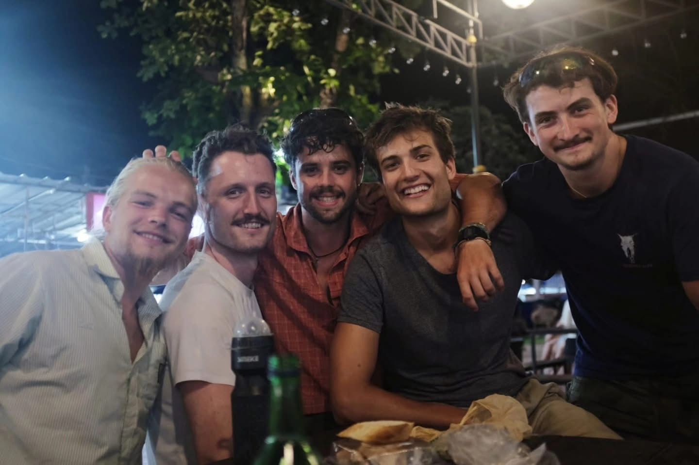 Five young men smiling. 