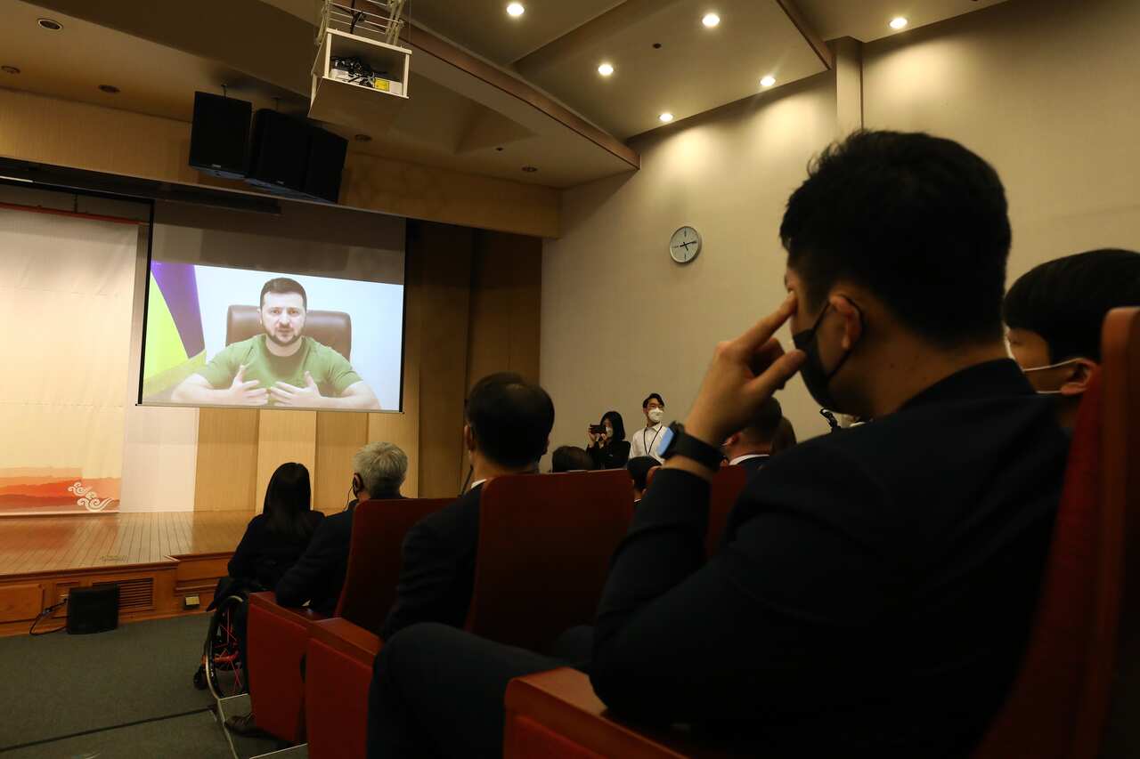 Ukraine's President Volodymyr Zelenskyy is seen on a screen while addressing South Korea's parliament.