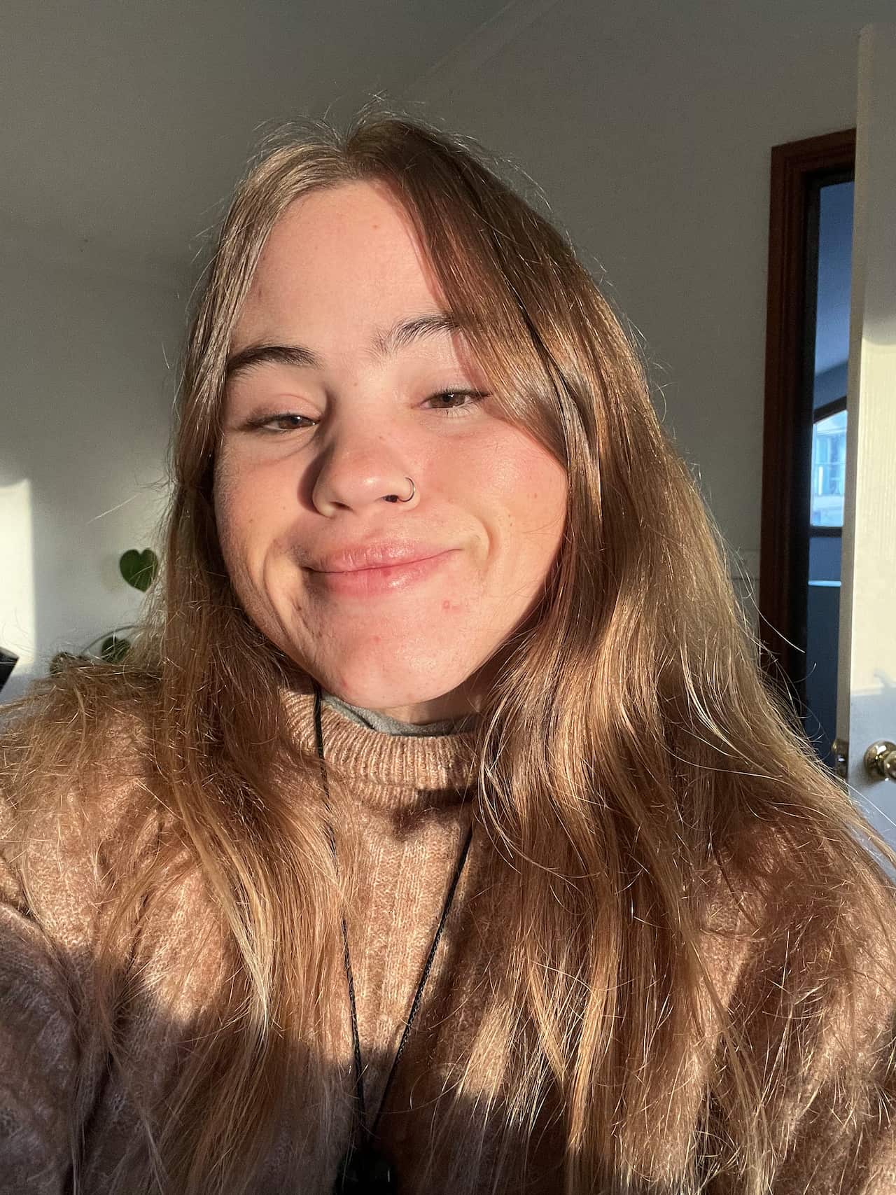 A selfie of a woman with long hair smiling