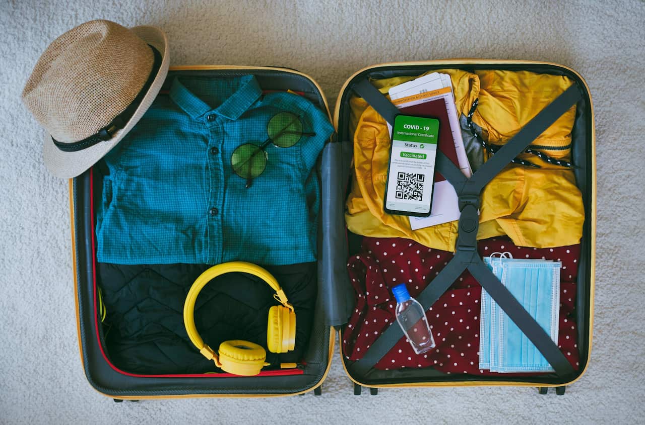 Suitcase with vaccine certificate Getty Images.png