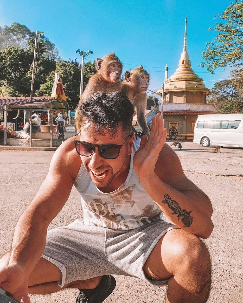 Luca Ferraina in Thailand with two little monkeys