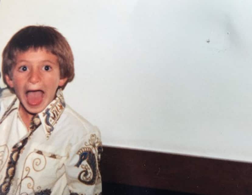 Young boy smiling for a photo.