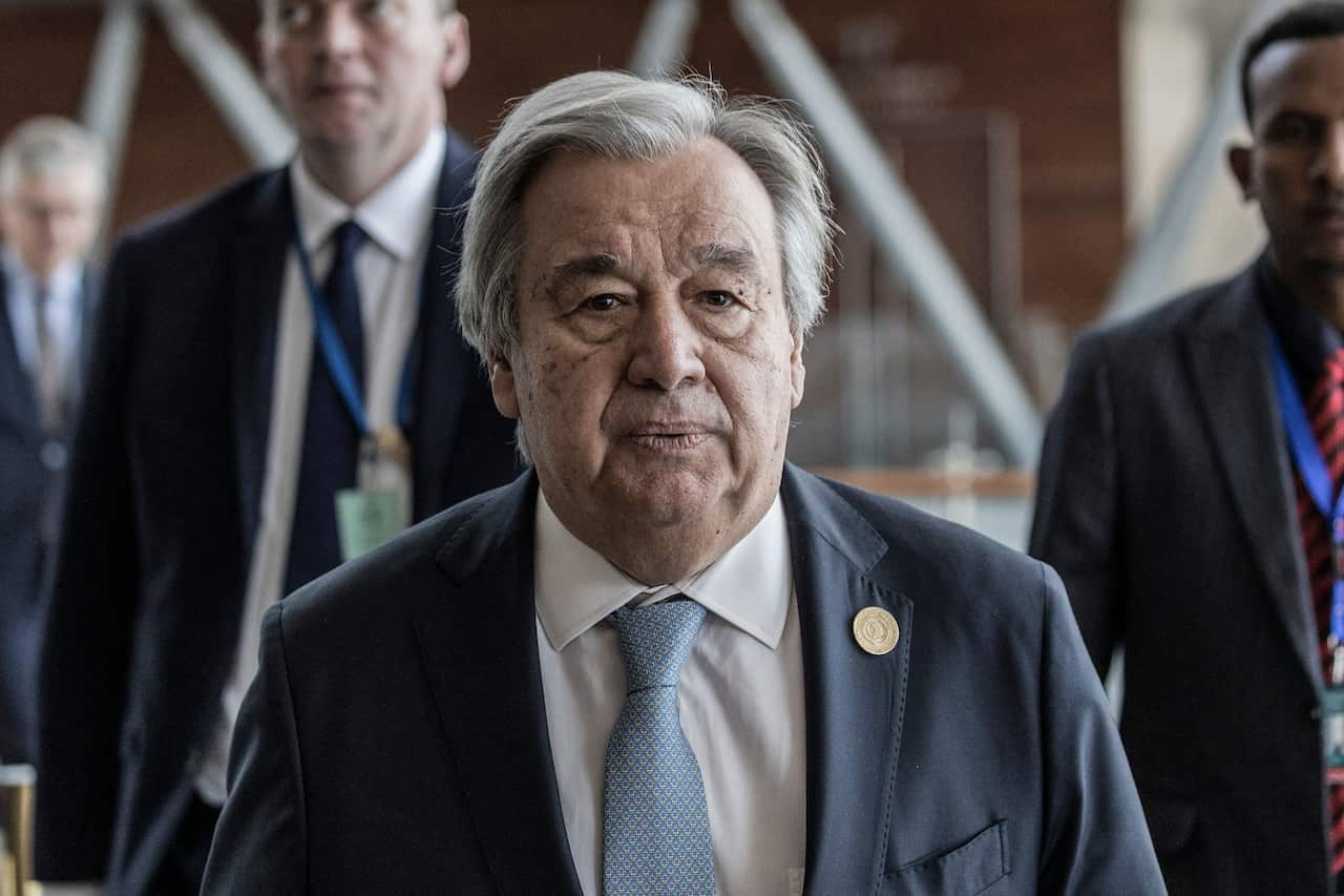 Man stands in a suit. 