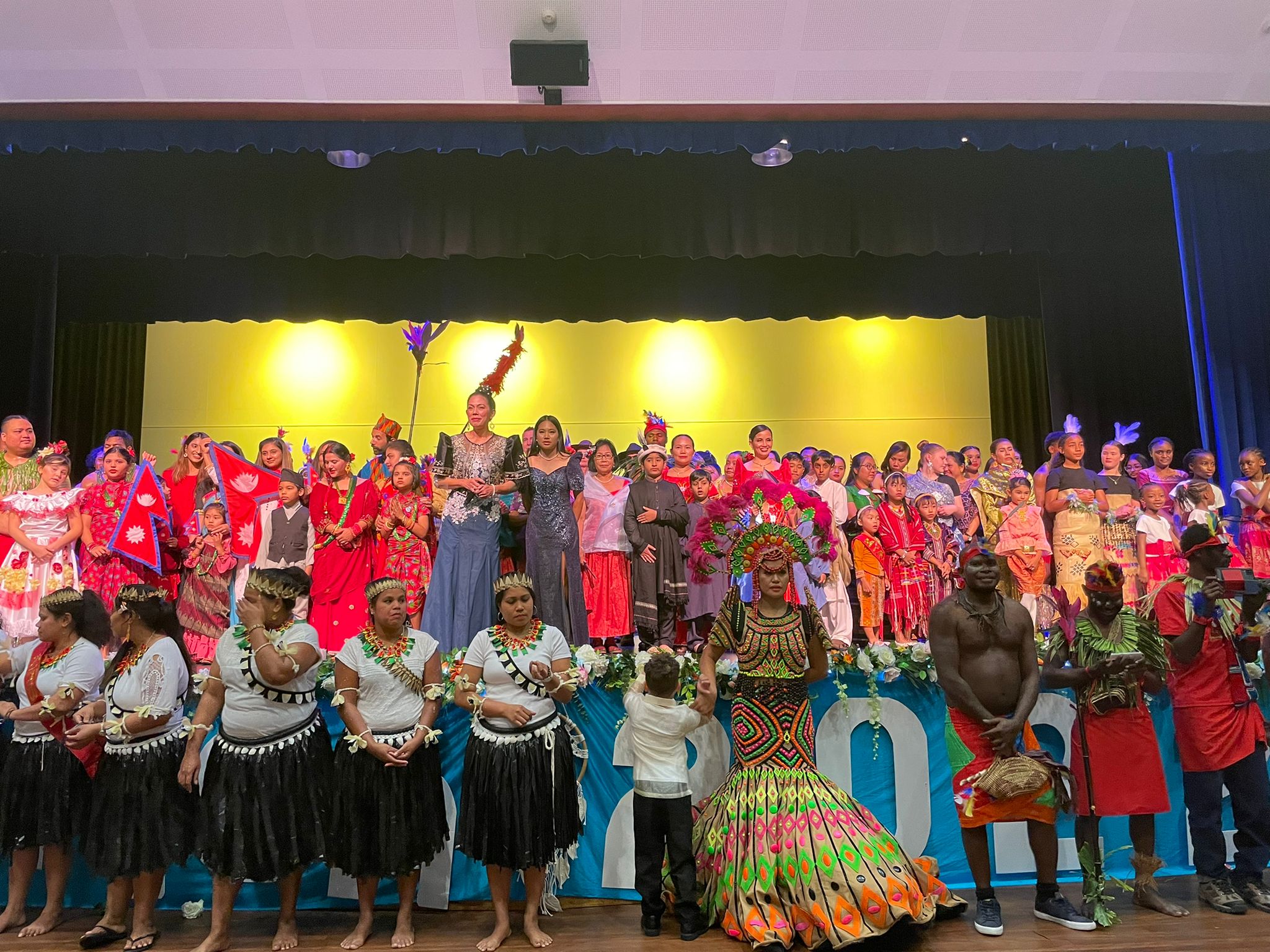 Several people stand in a line showcasing their costumes.