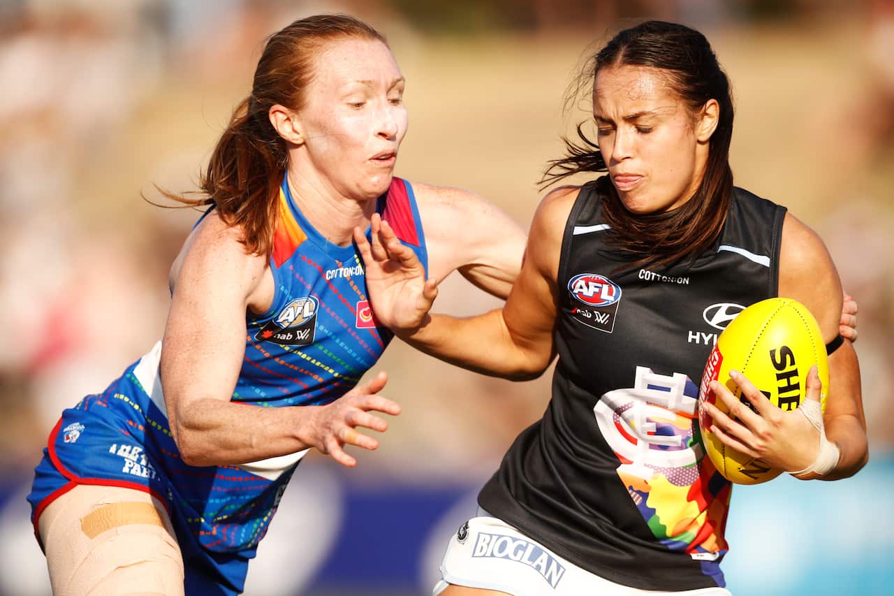 AFLW players Tiarna Ernst and Brooke Walker on the field.