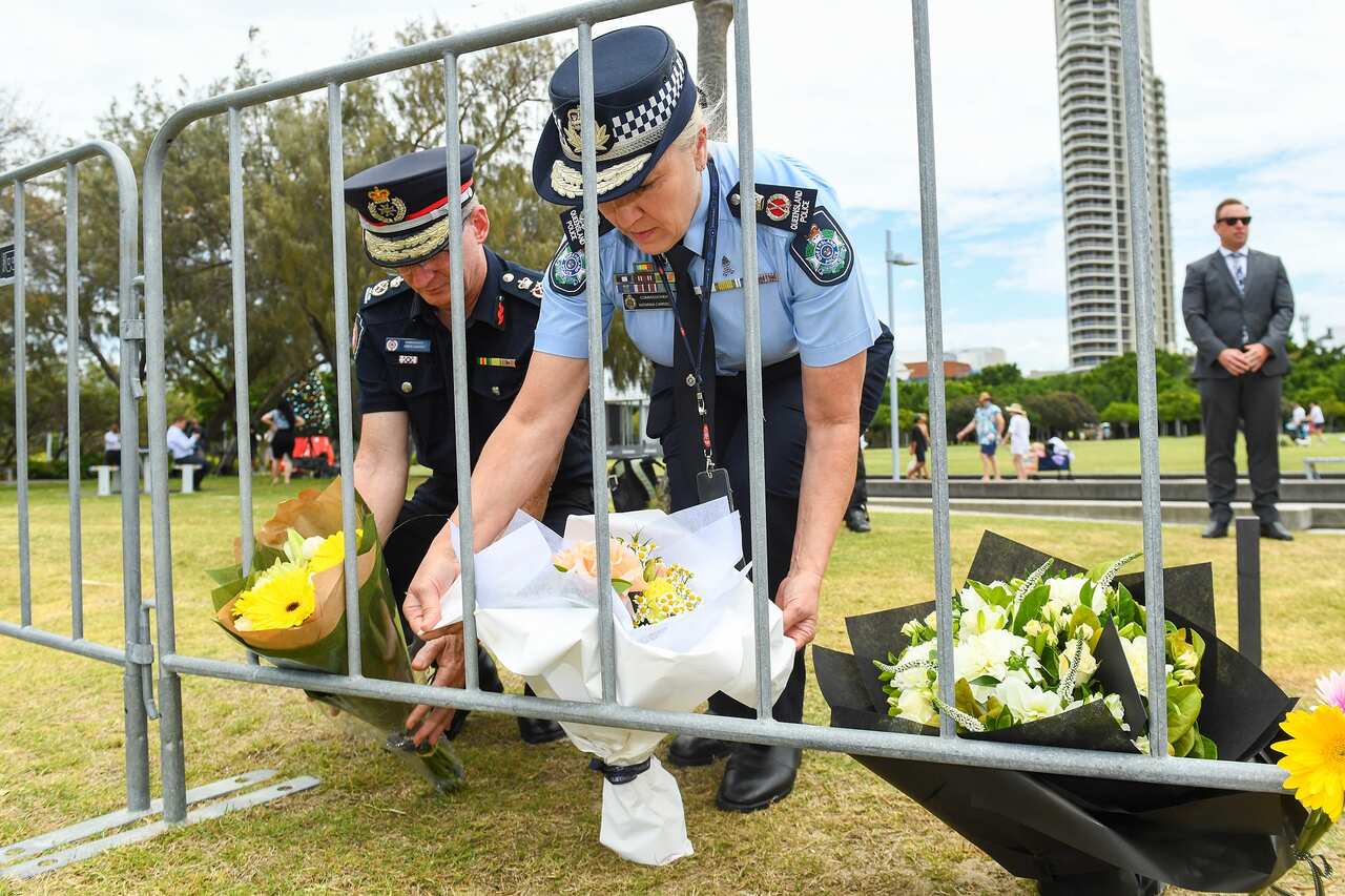 Queensland. Fire and Emergency Services commissioner Greg Leach and Police Commissioner Katarina Carroll place a floral tribute at the Broadwater Parklands on the Gold Coast on 3 January 2023. 