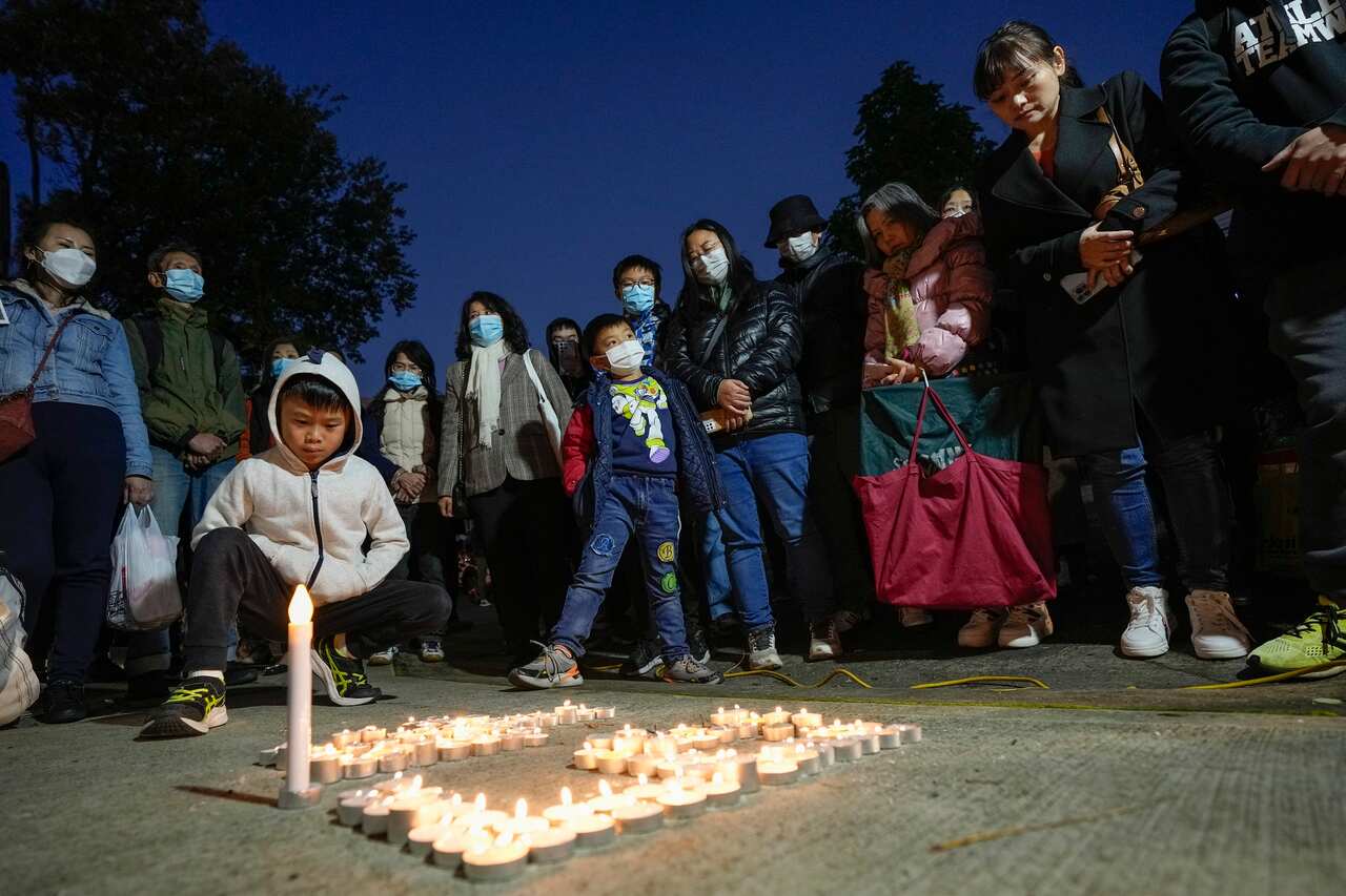 Pro-democracy supporters place candles on the ground outside the Chinese Consulate in Sydney.