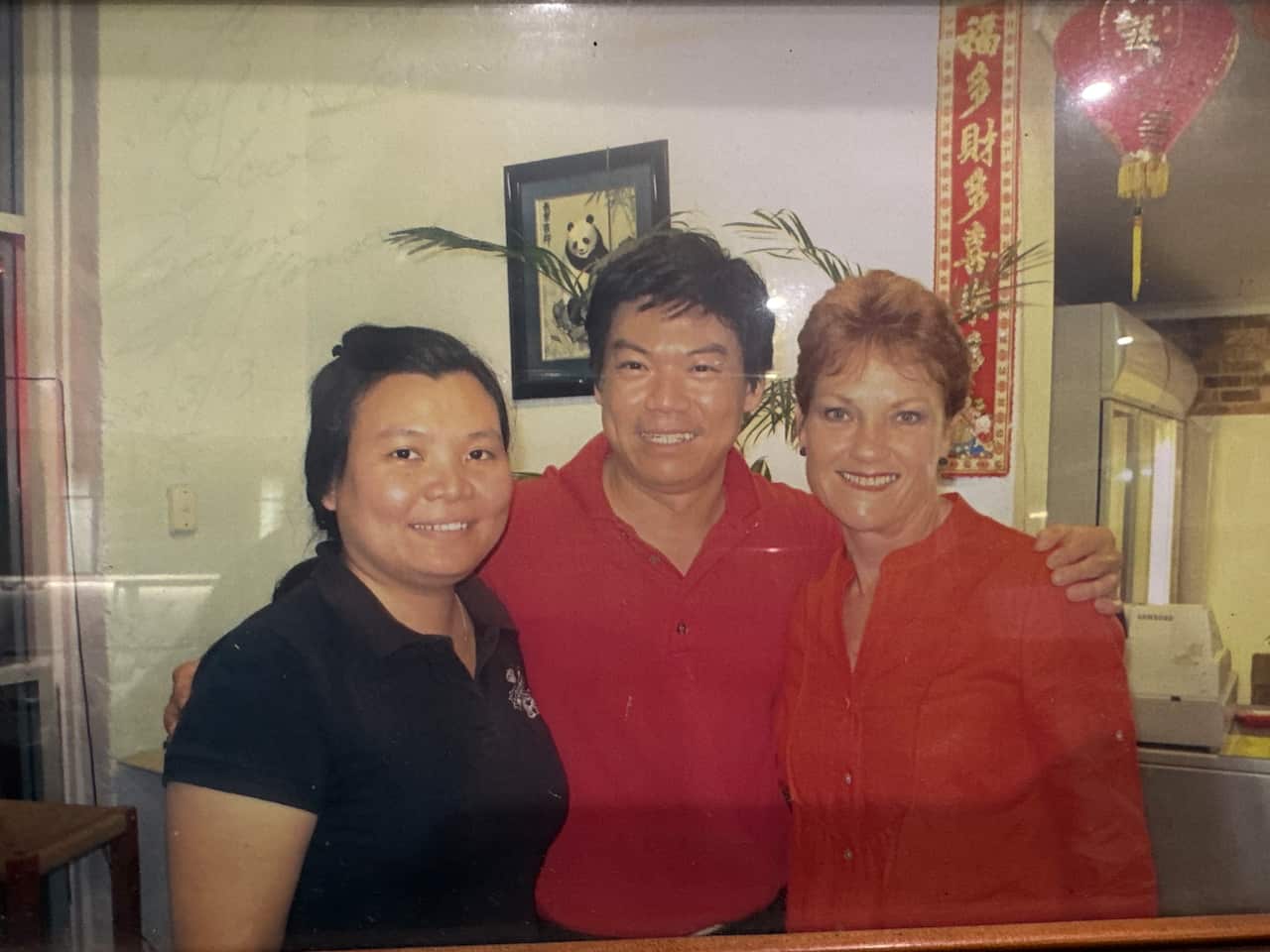 A signed photo showing a Malaysian Chinese couple posing with Pauline Hanson