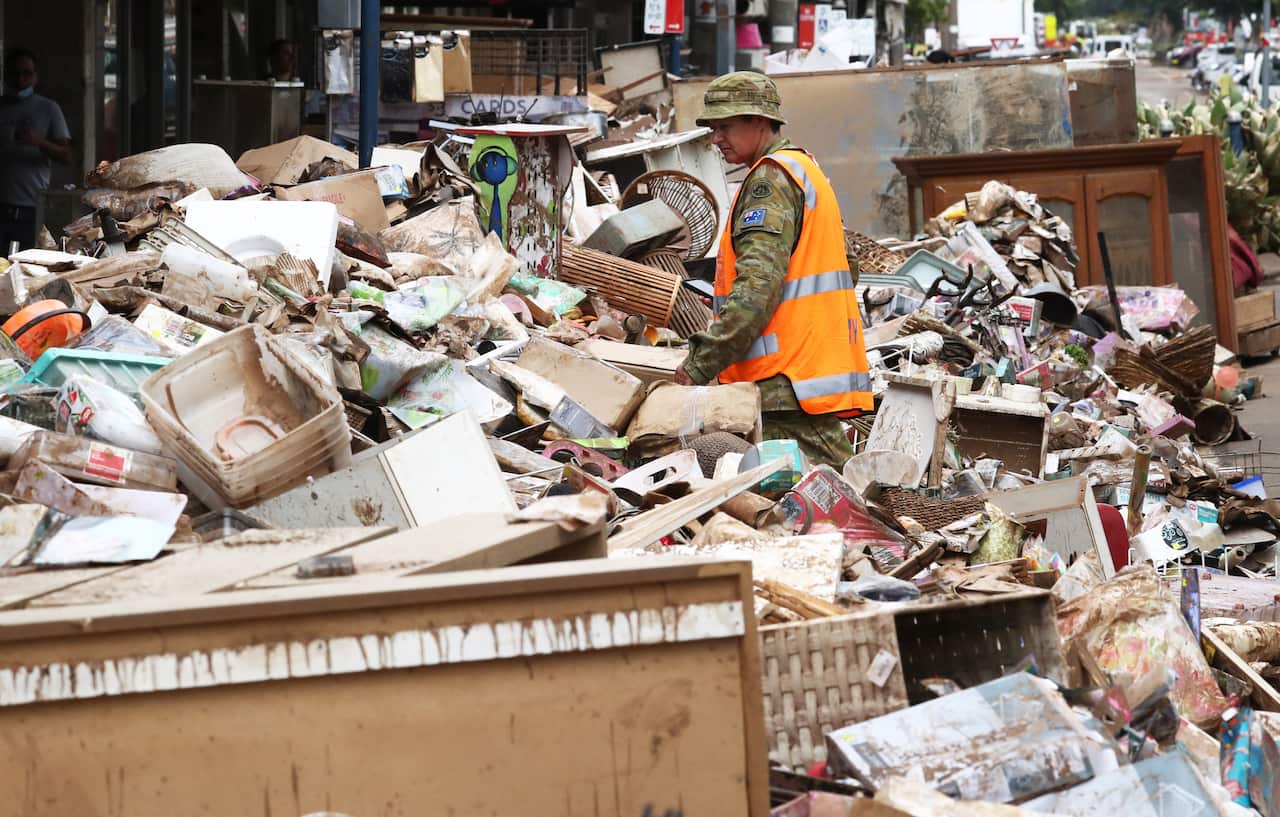 A member of the Australian Defence Force helps with the flood cleanup in Lismore.