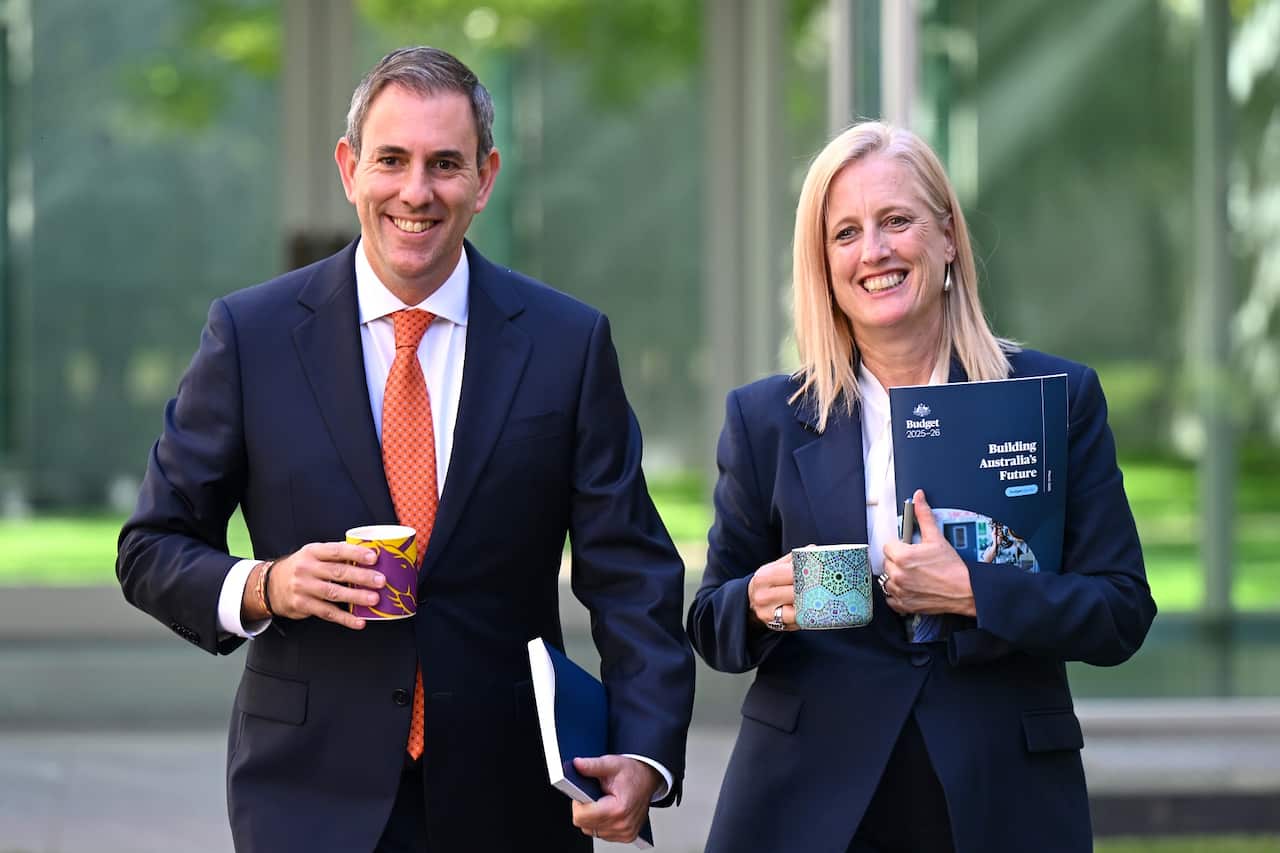 Jim Chalmers and Katy Gallagher standing next to each other outside and smiling.