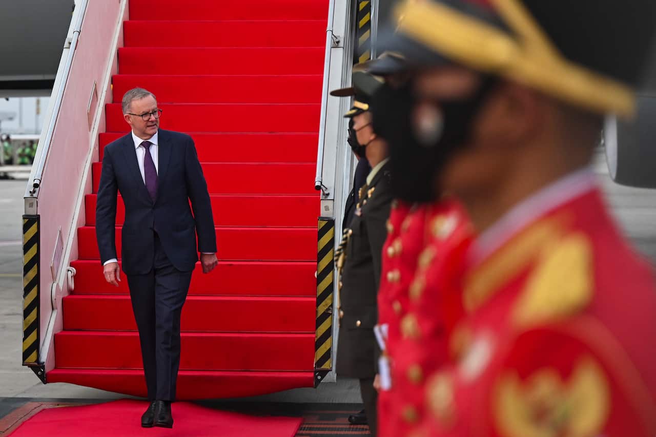 A man walking from a plane.