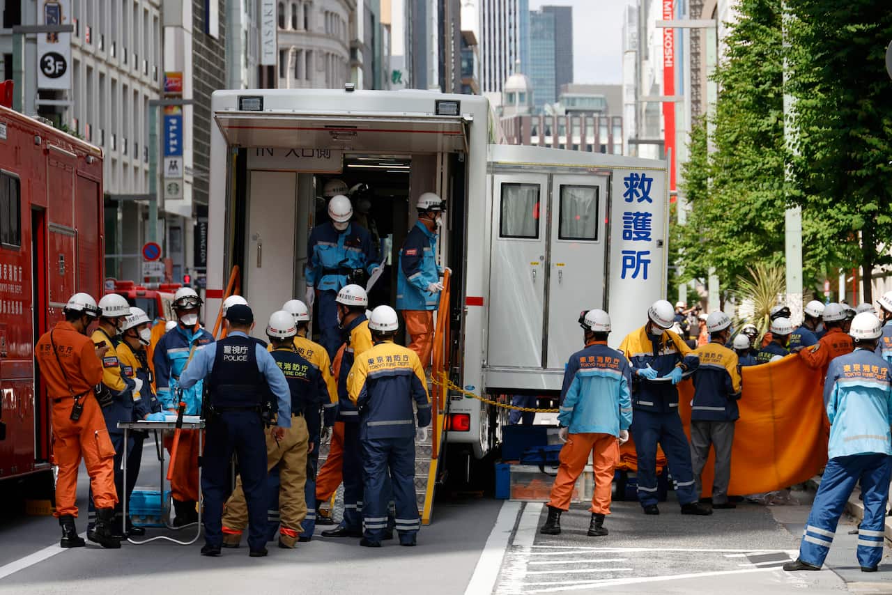 Emergency personnel around an ambulance are seen outside a shopping centre