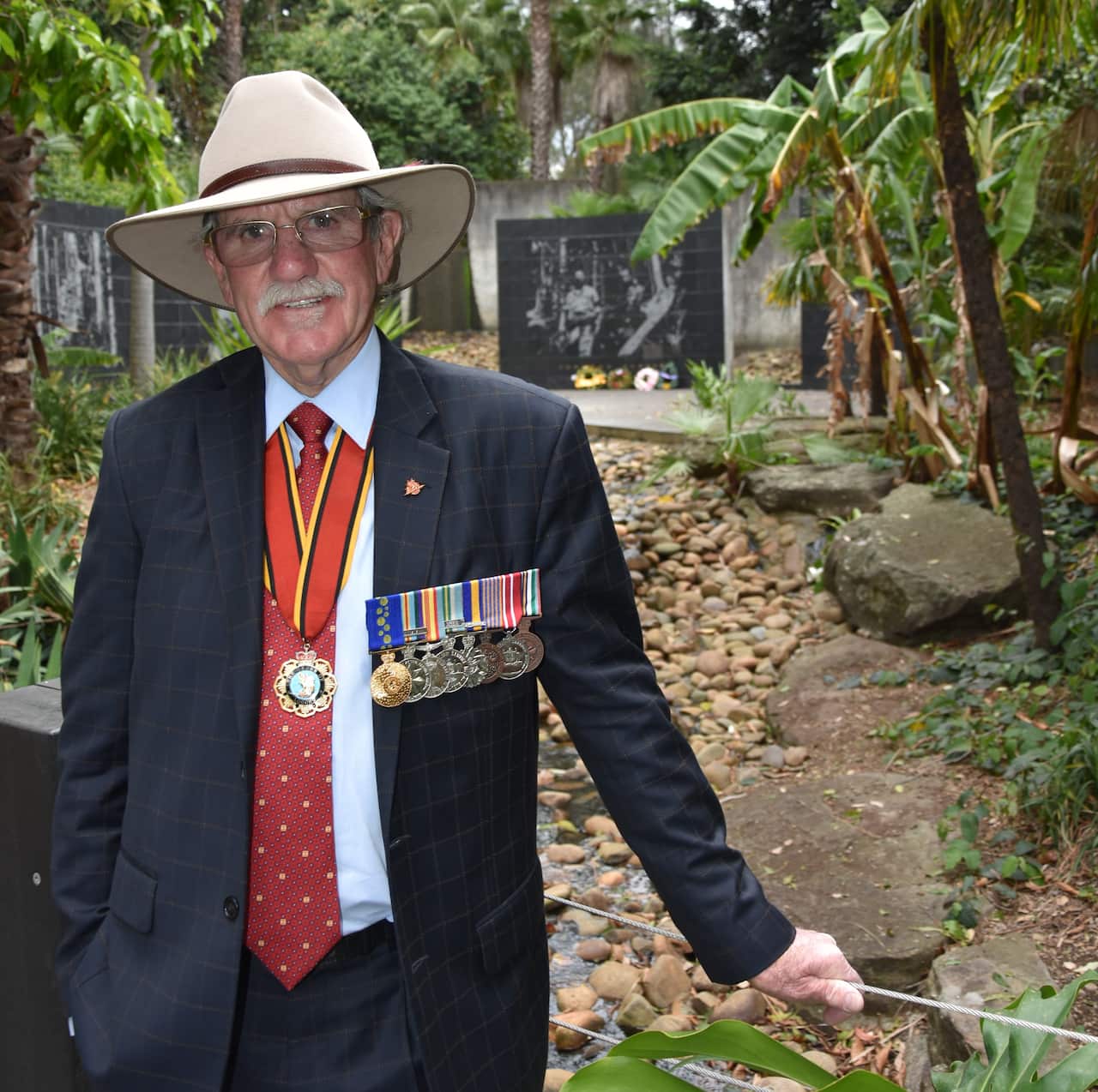 A man in a suit wearing military medals