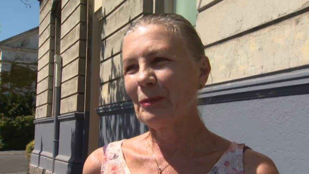 A woman standing in front of a building