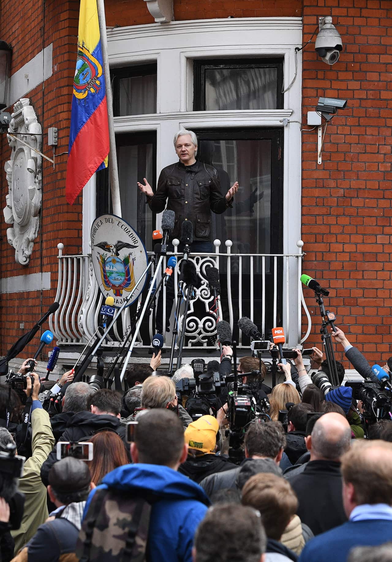 Julian Assange speaks to reporters from a balcony at the Ecuadorian embassy in London.