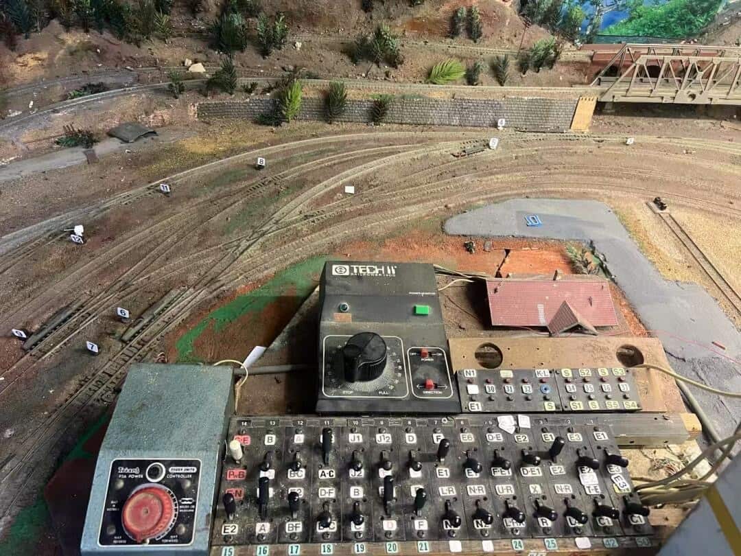 An old, dusty control board for a model train network.