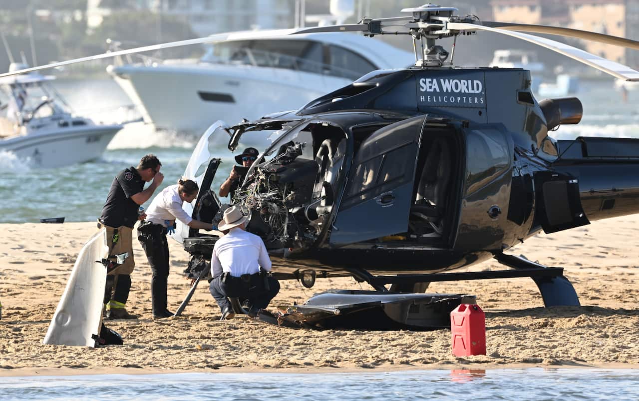 Helicopter with a damaged windscreen on the sandbank.