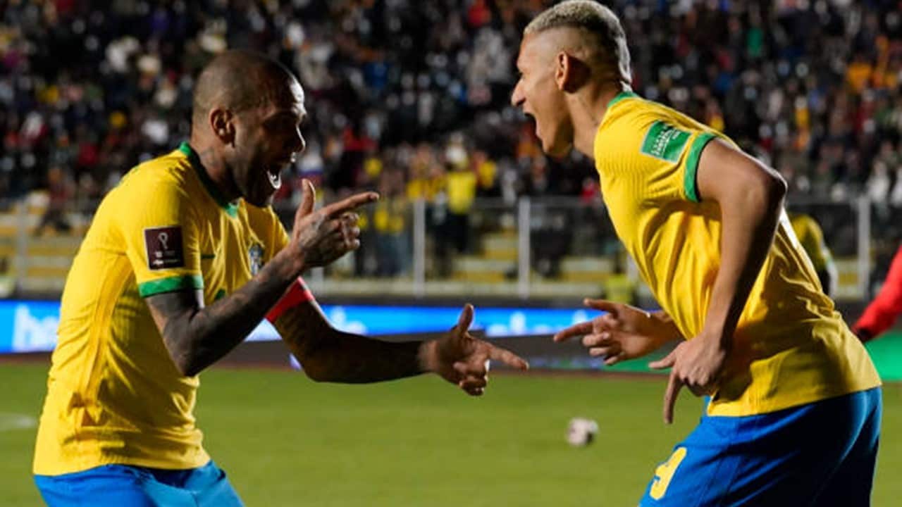 Richarlison of Brazil celebrates with teammate Dani Alves after scoring the fourth goal of his team.jpg