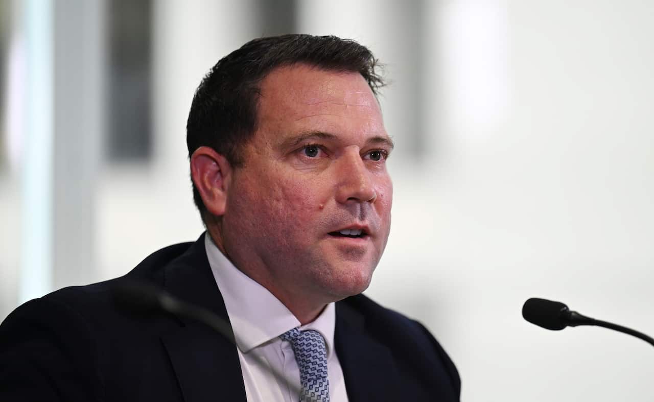 A man speaks at a press conference.