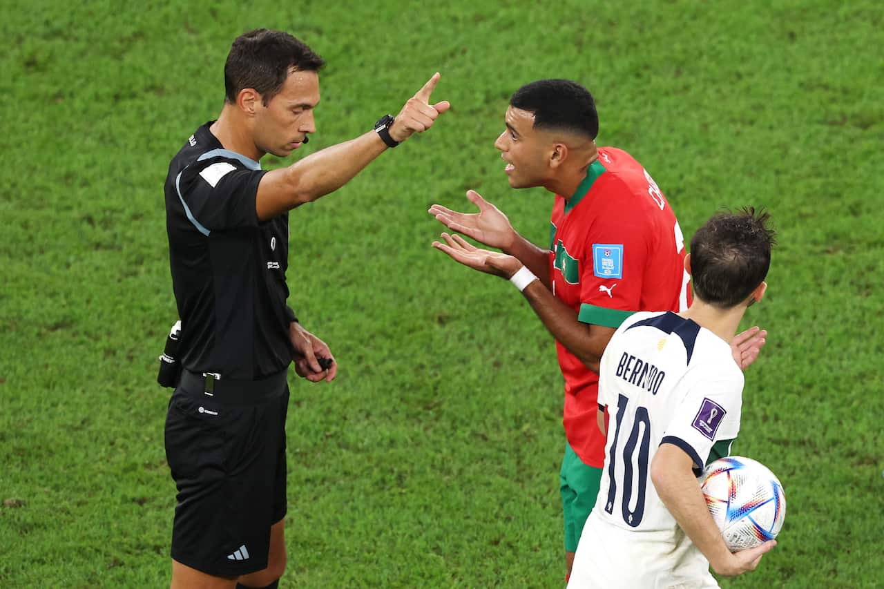 A football player arguing with a referee 