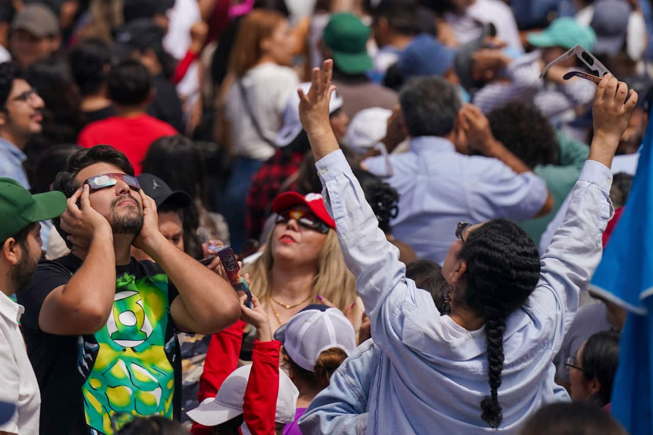 People watch a total solar eclipse in Mazatlan, Mexico