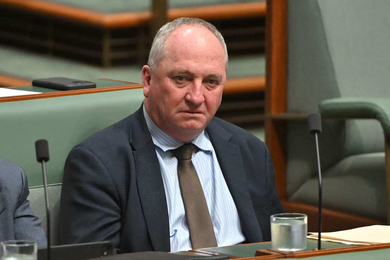 A man in a suit sits in parliament.
