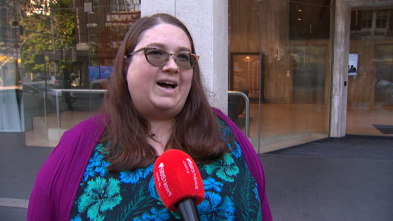 A woman speaking into a microphone.