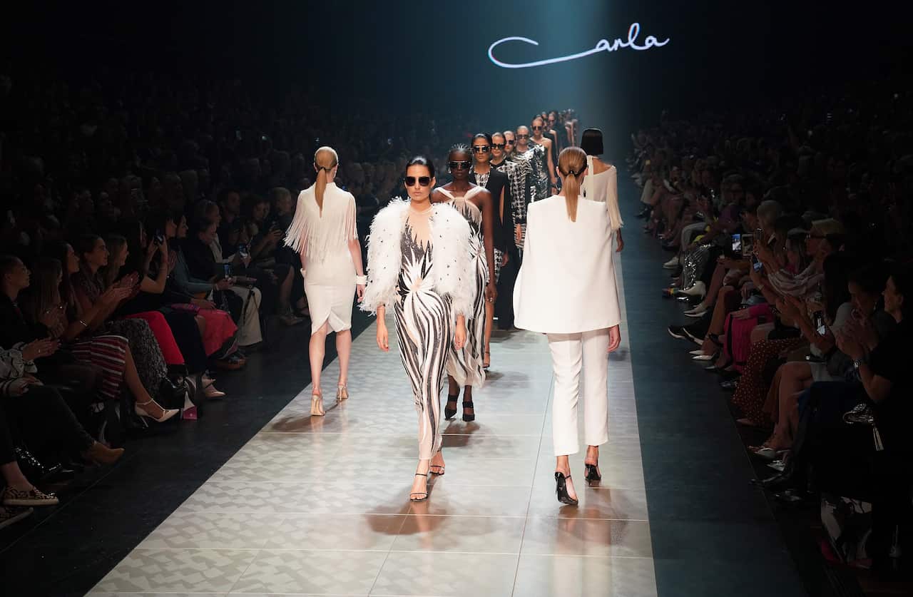 Models wearing Carla Zampatti walk the runway during the Virgin Australia Grand Showcase as part of the 2019 Melbourne Fashion Festival in Melbourne.