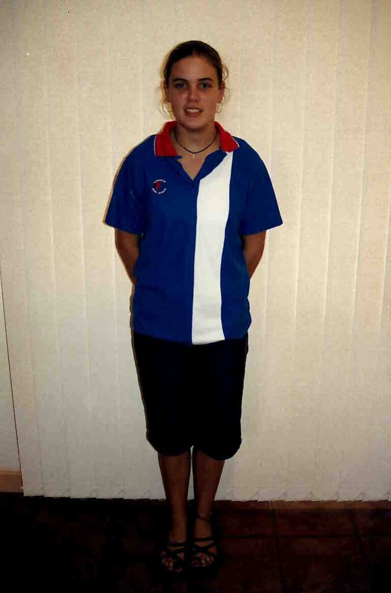 Leigh-Anne in high school, wearing her school uniform. 