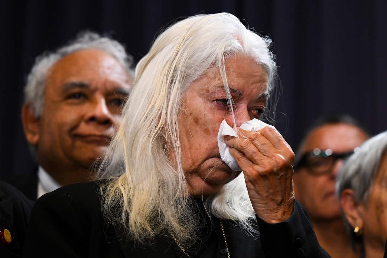 Marcia Langton wipes her nose with a handkerchief as she cries.
