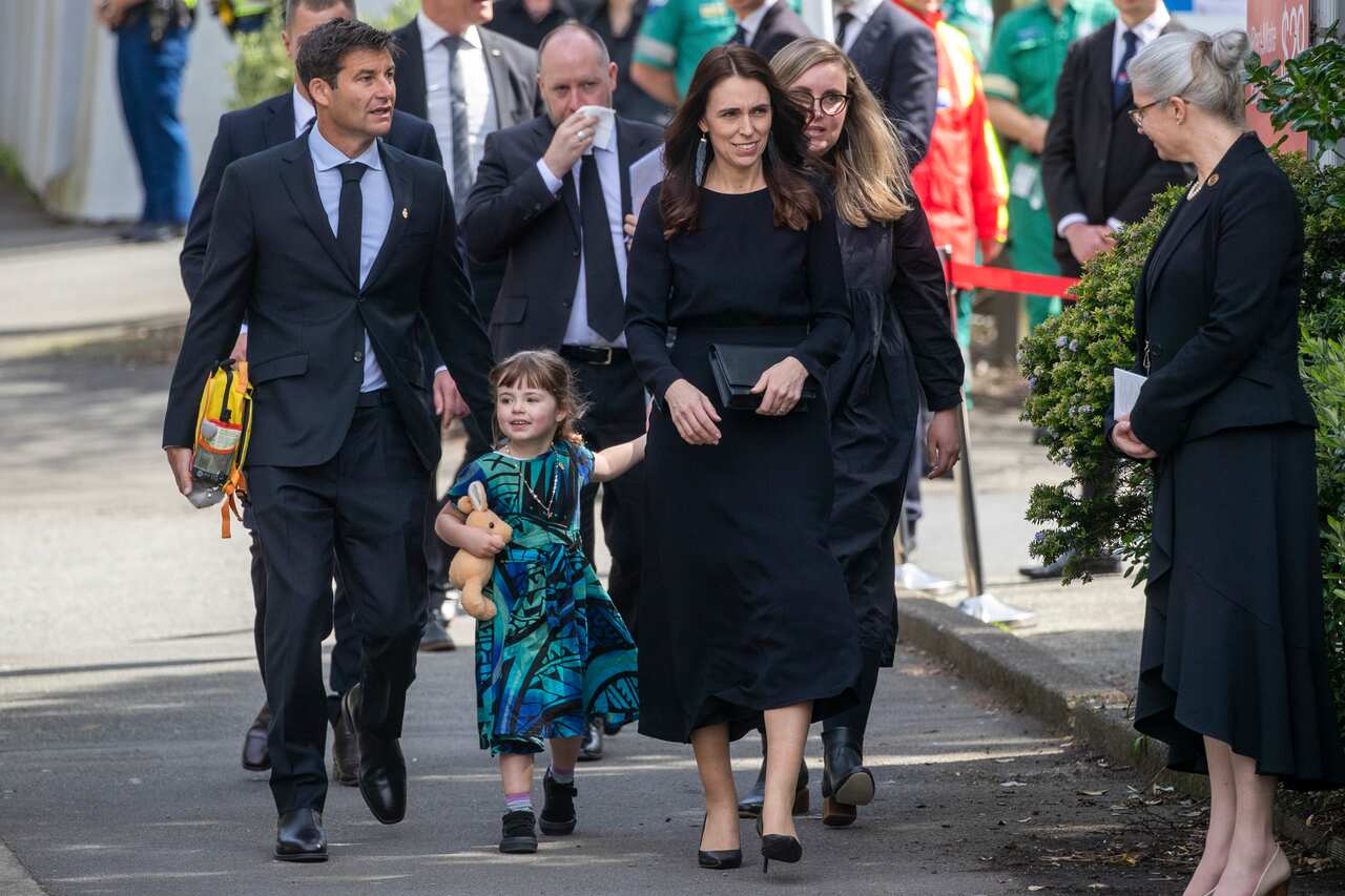 Jacinda Ardern walking with her family.