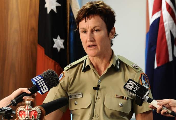 A woman in a khaki uniform at a press conference