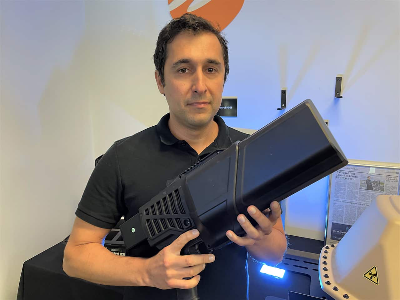 DroneShield CEO Oleg Vornik holding a counter drone device.