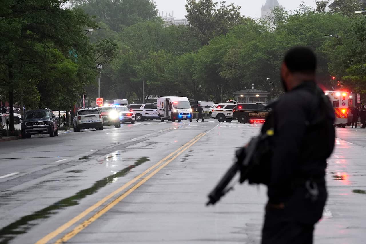 A Secret Service agent stands on the street.